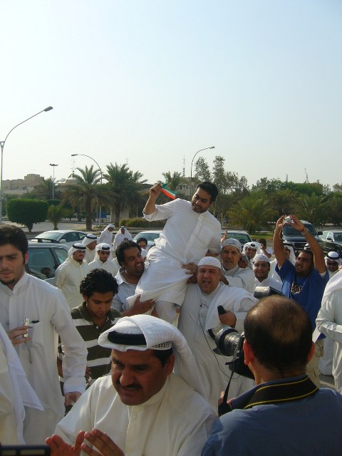 Kuwaiti blogger Bashar Al-Sayegh being carried by supporters after his release