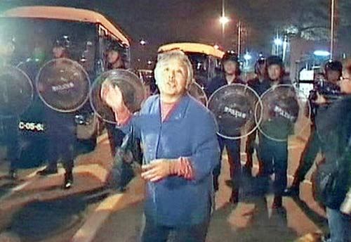 The senior woman accused the riot police of subduing citizens with no weapon